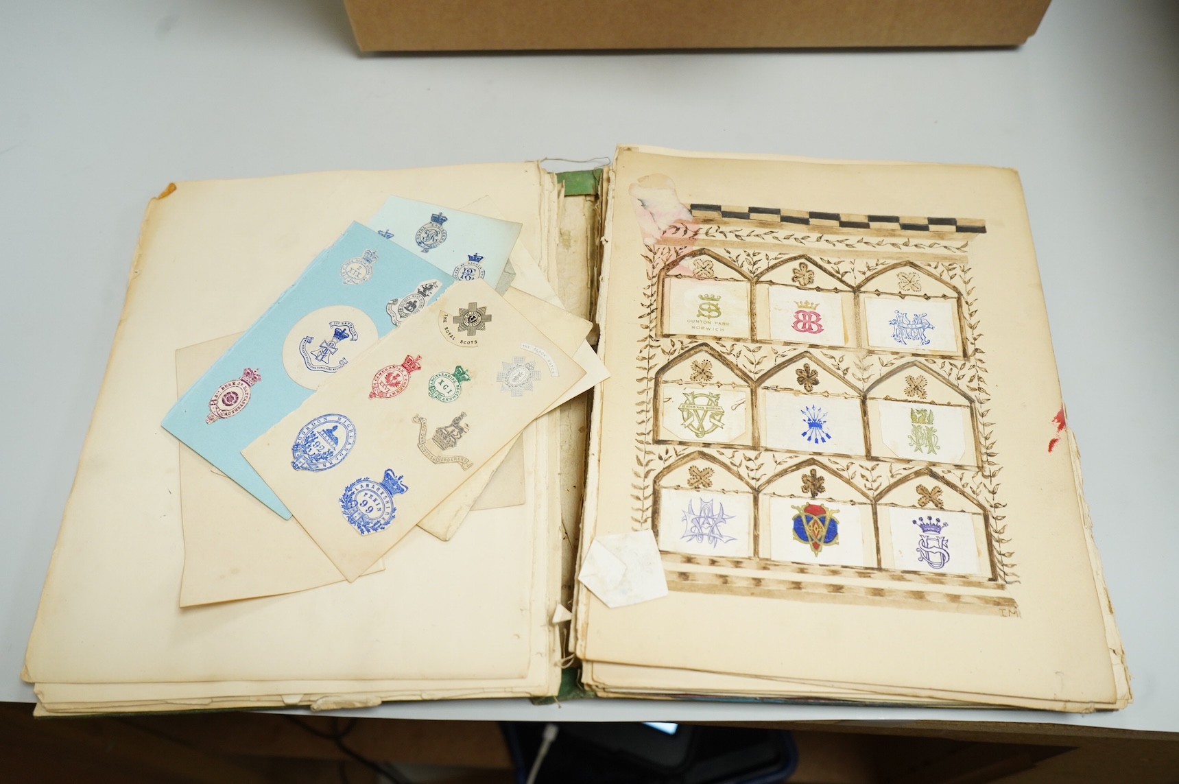 A collection of Victorian and later crest and monogram albums and loose crests and monograms